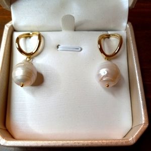 Pearl dangle earrings with gold colored tops